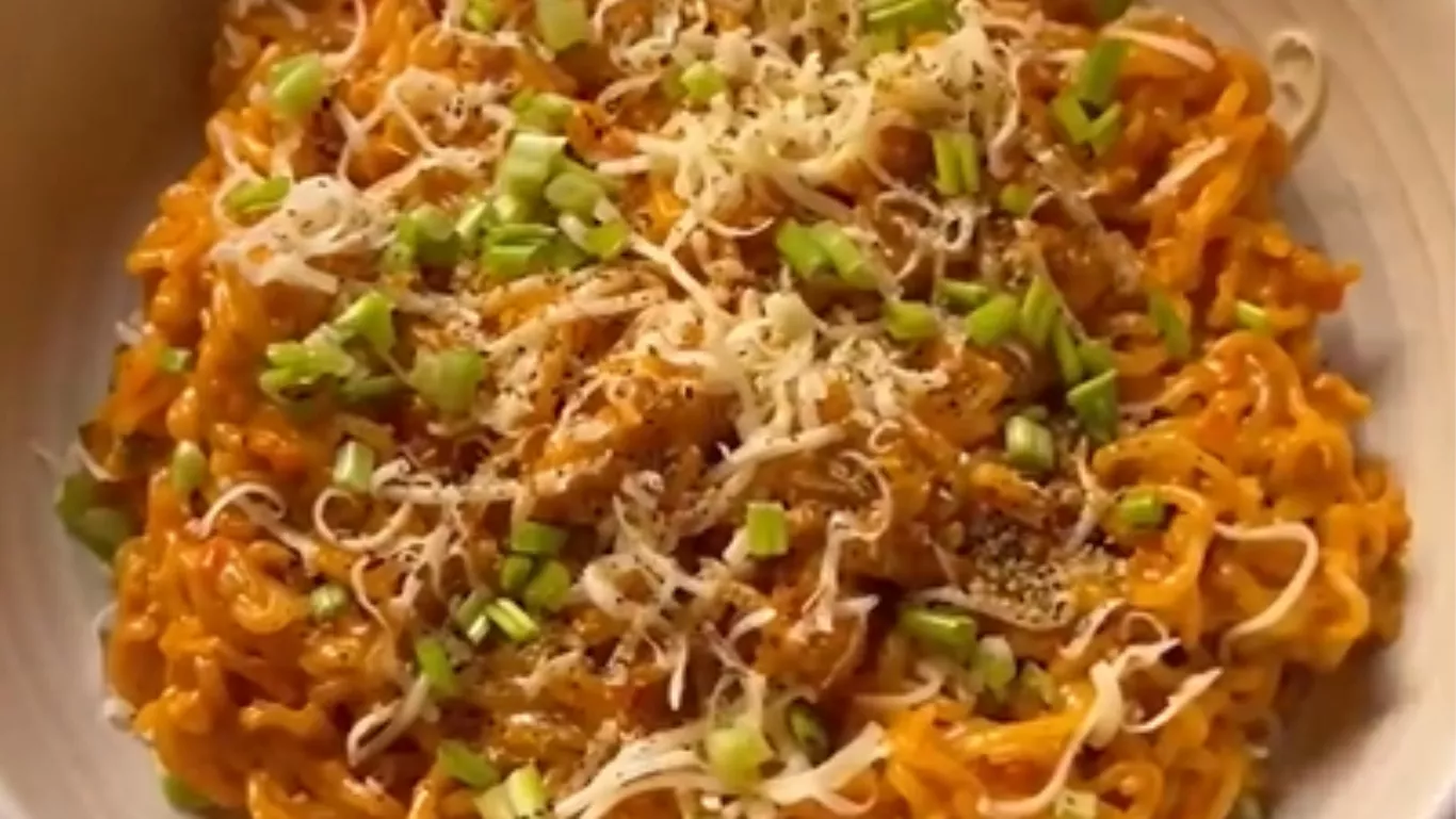 Creamy butter garlic cheesy noodles topped with cheese and spring onions